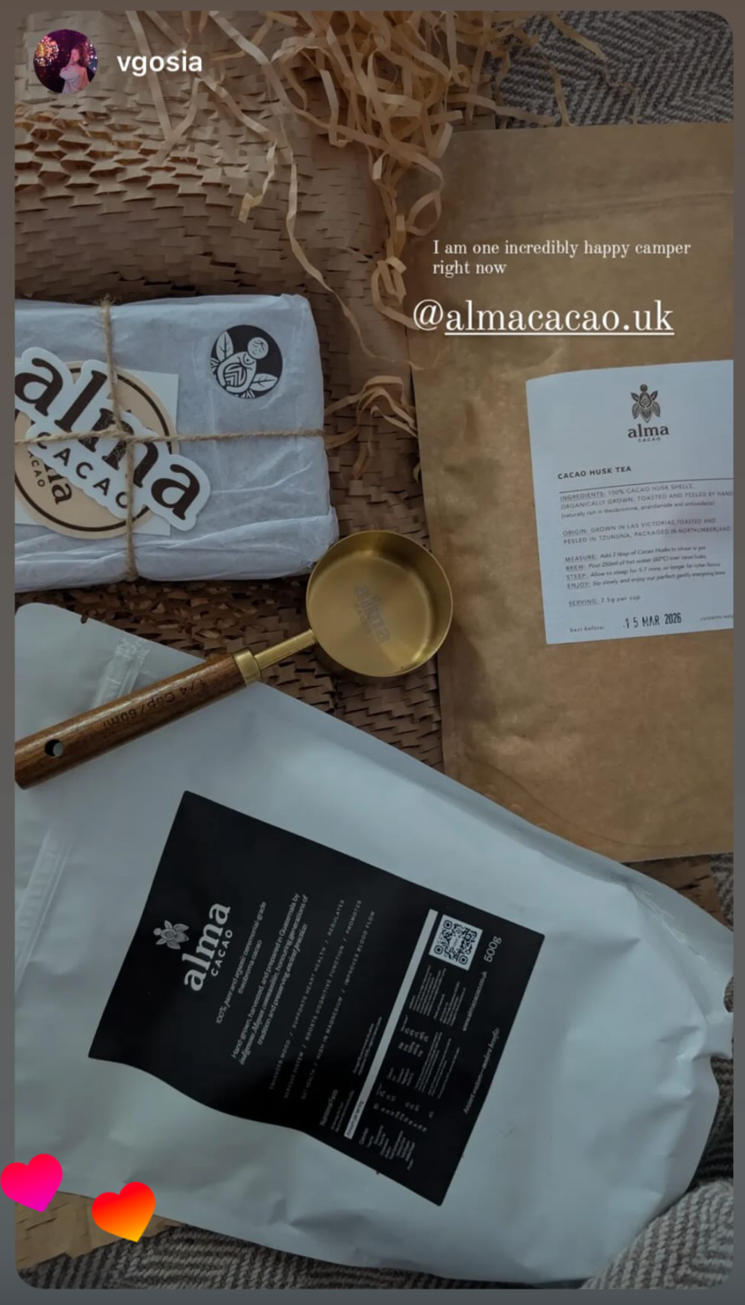 Alma Cacao products including bags, a spoon, and a label on a textured surface.