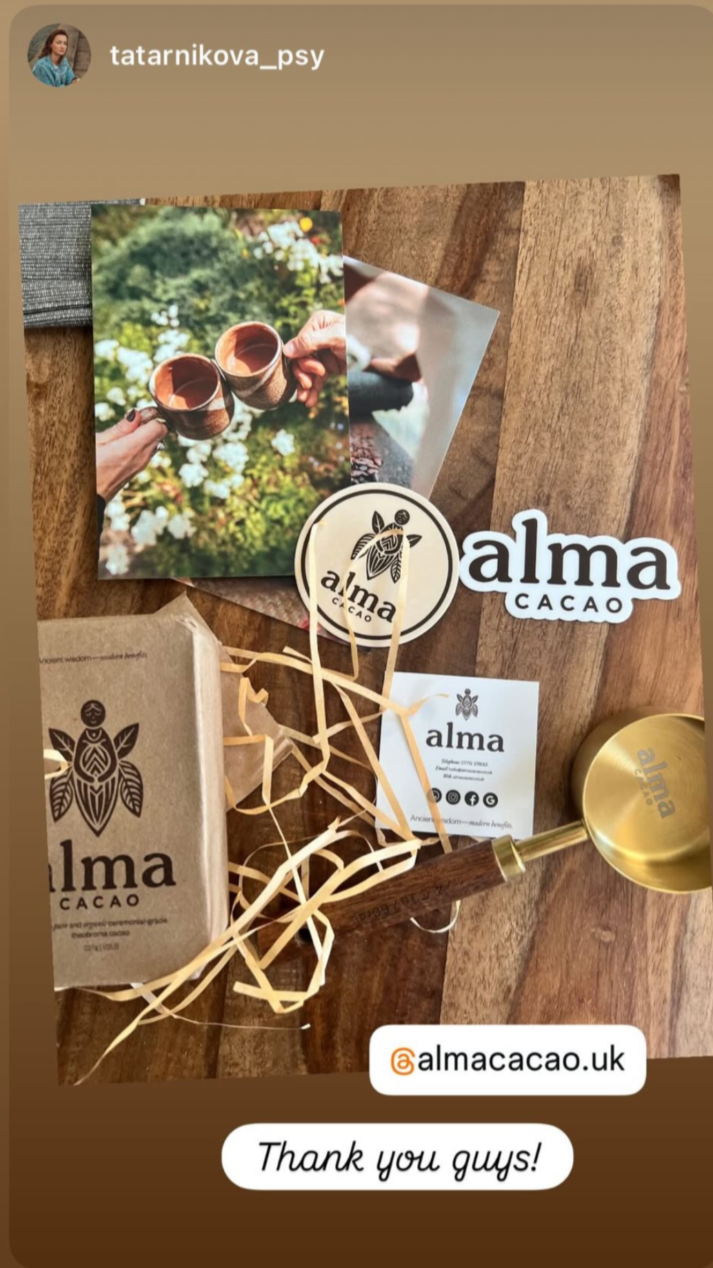 Alma Cacao products on a wooden surface with branding and social media handle displayed.